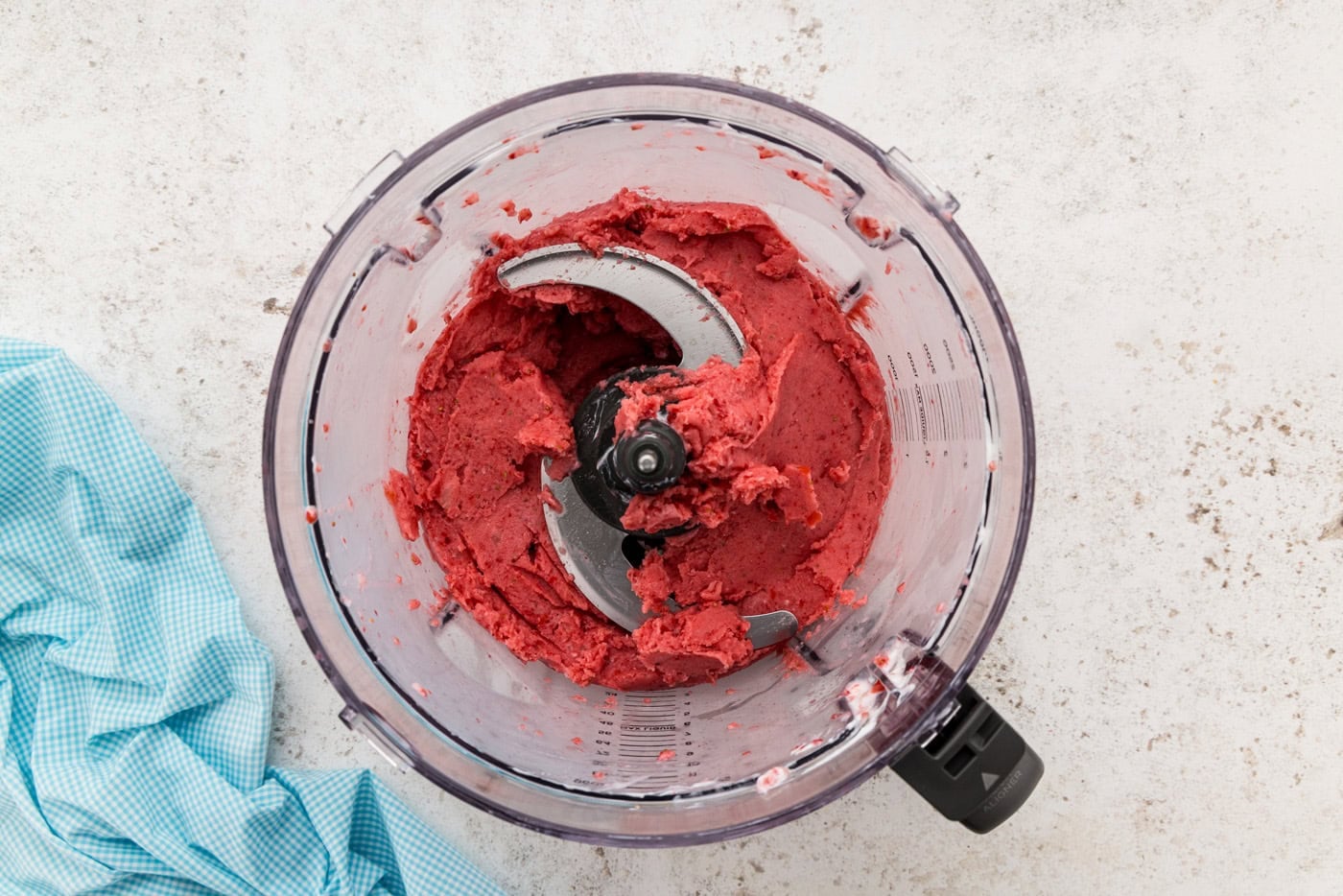 frozen strawberries in food processor smashed up