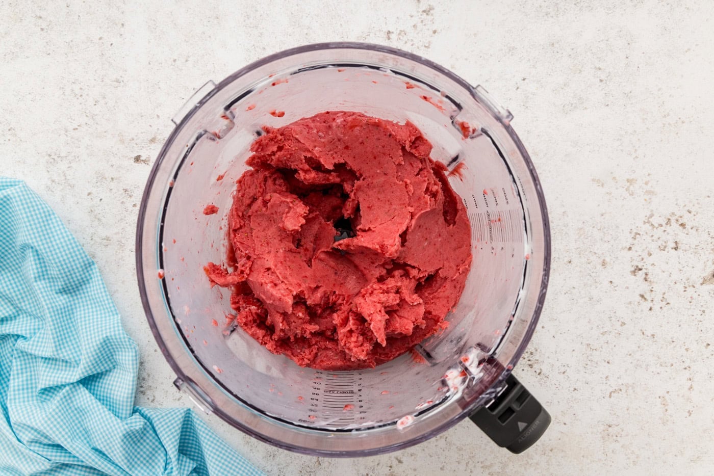 mixed frozen strawberries in food processor