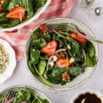 two bowls of Strawberry Spinach Salad with a pink checkered linen