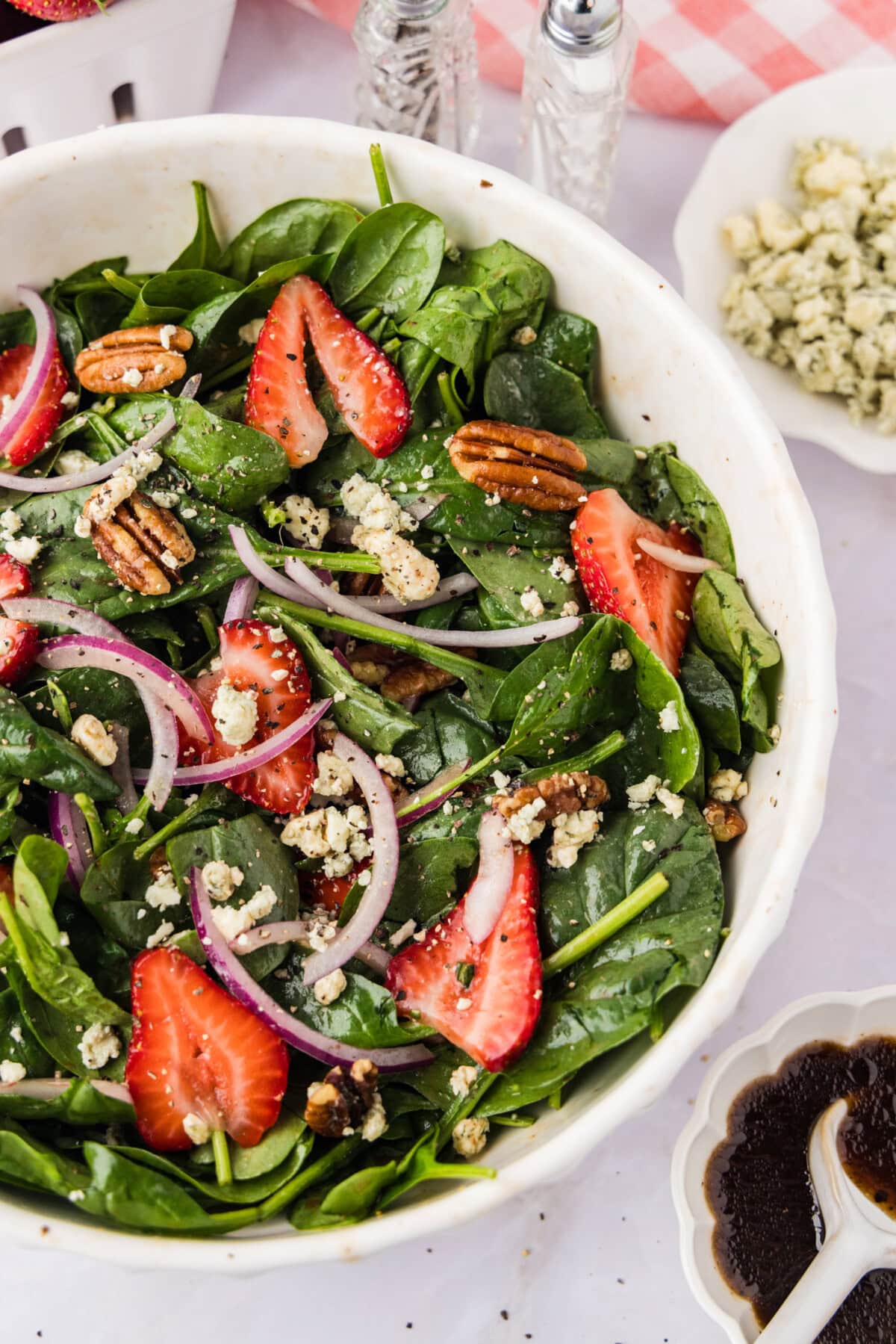 Strawberry Spinach Salad with dressing and crumbled cheese