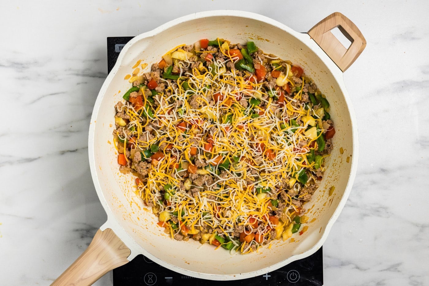 ground turkey in skillet with peppers and cheese