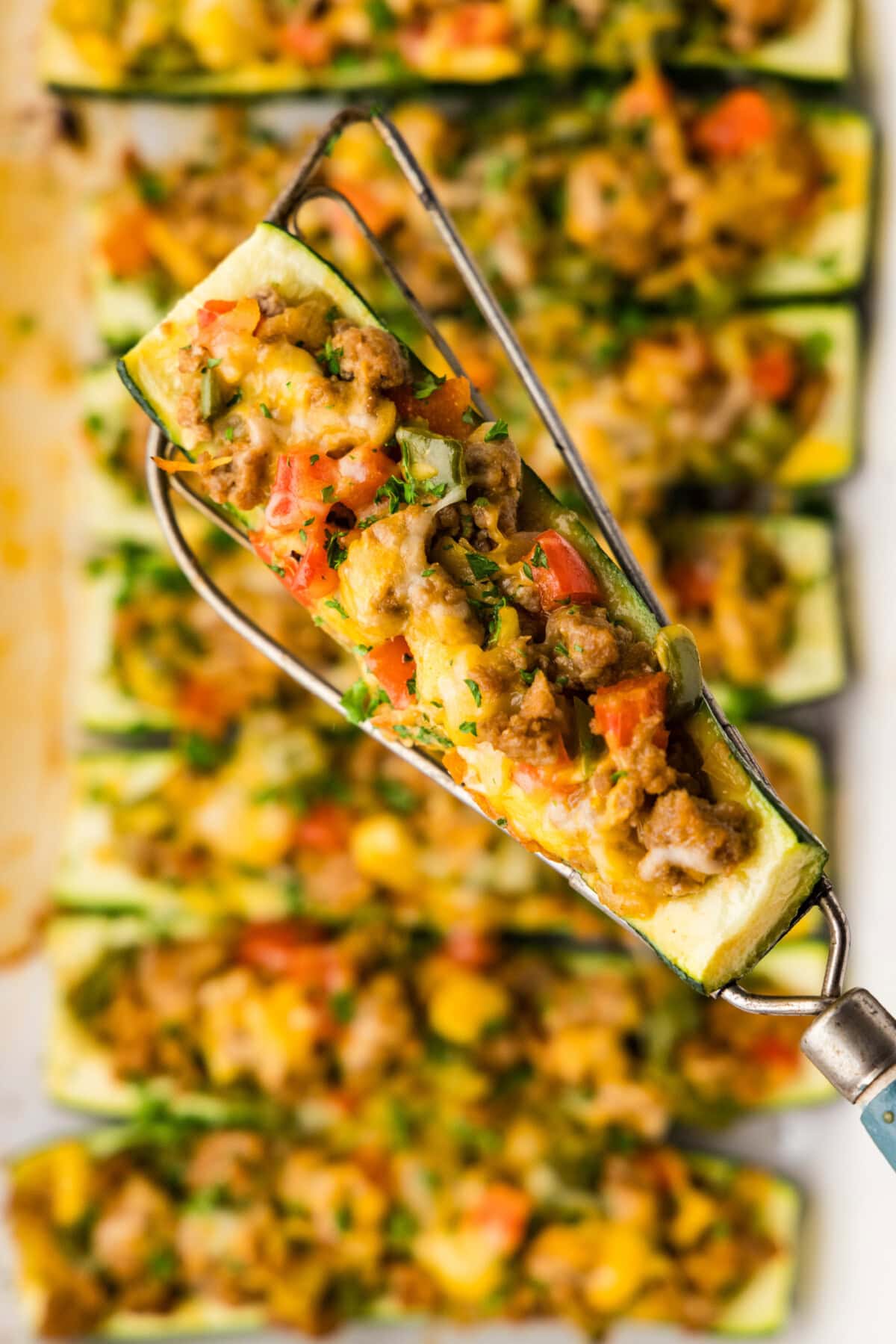 spatula lifting a Stuffed zucchini boats