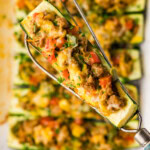 spatula lifting a Stuffed zucchini boats