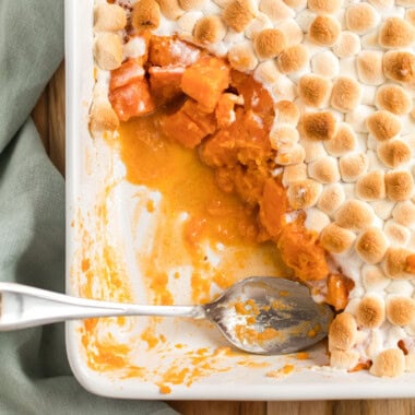 dish of candied yams with marshmallows with a spoon