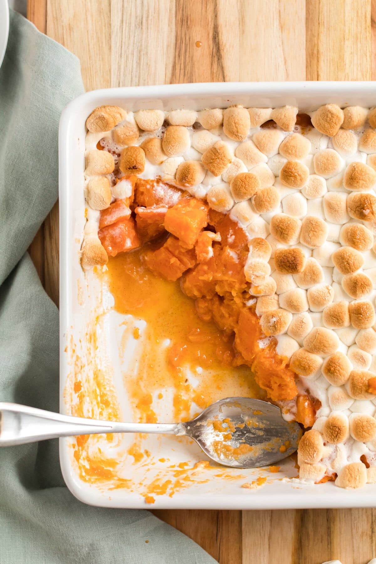 overhead of a casserole dish with candied yams topped with marshmallows