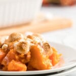 plate with a portion of candied yams with marshmallows