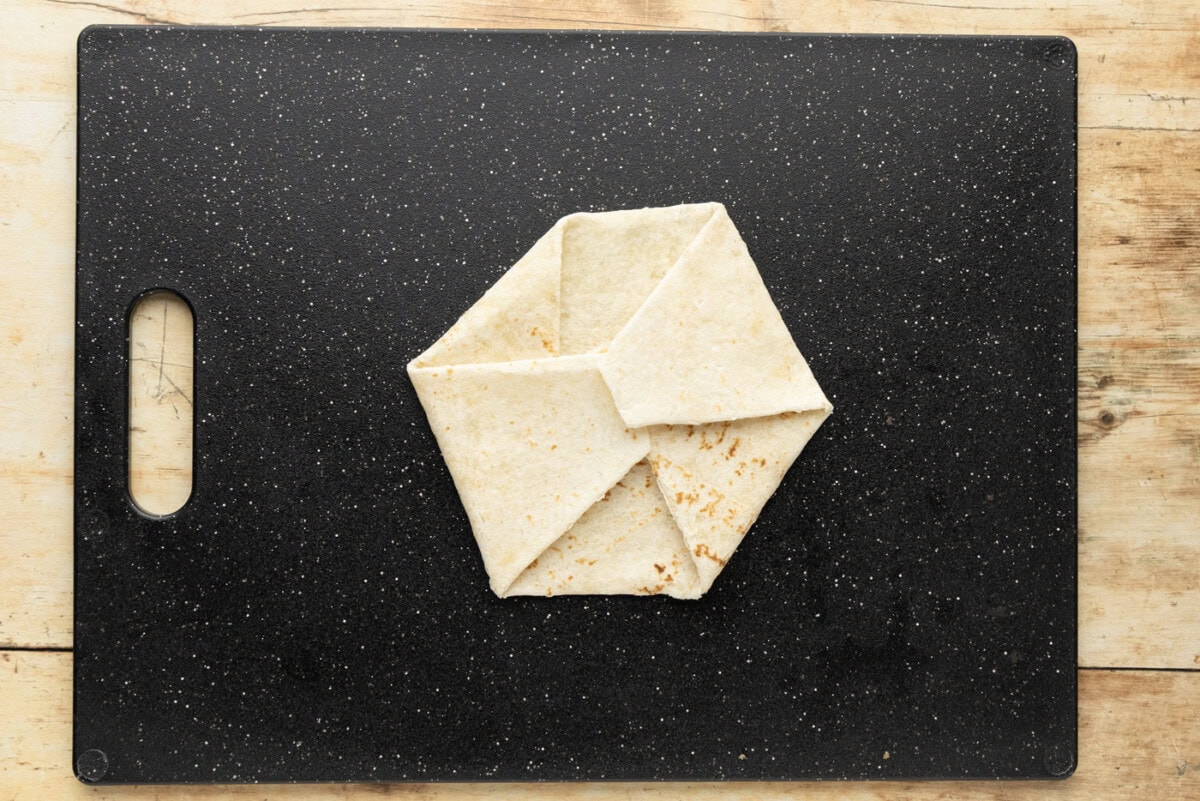 Finished six-sided Crunchwrap fold with a small pinwheel where all the folds meet in the center
