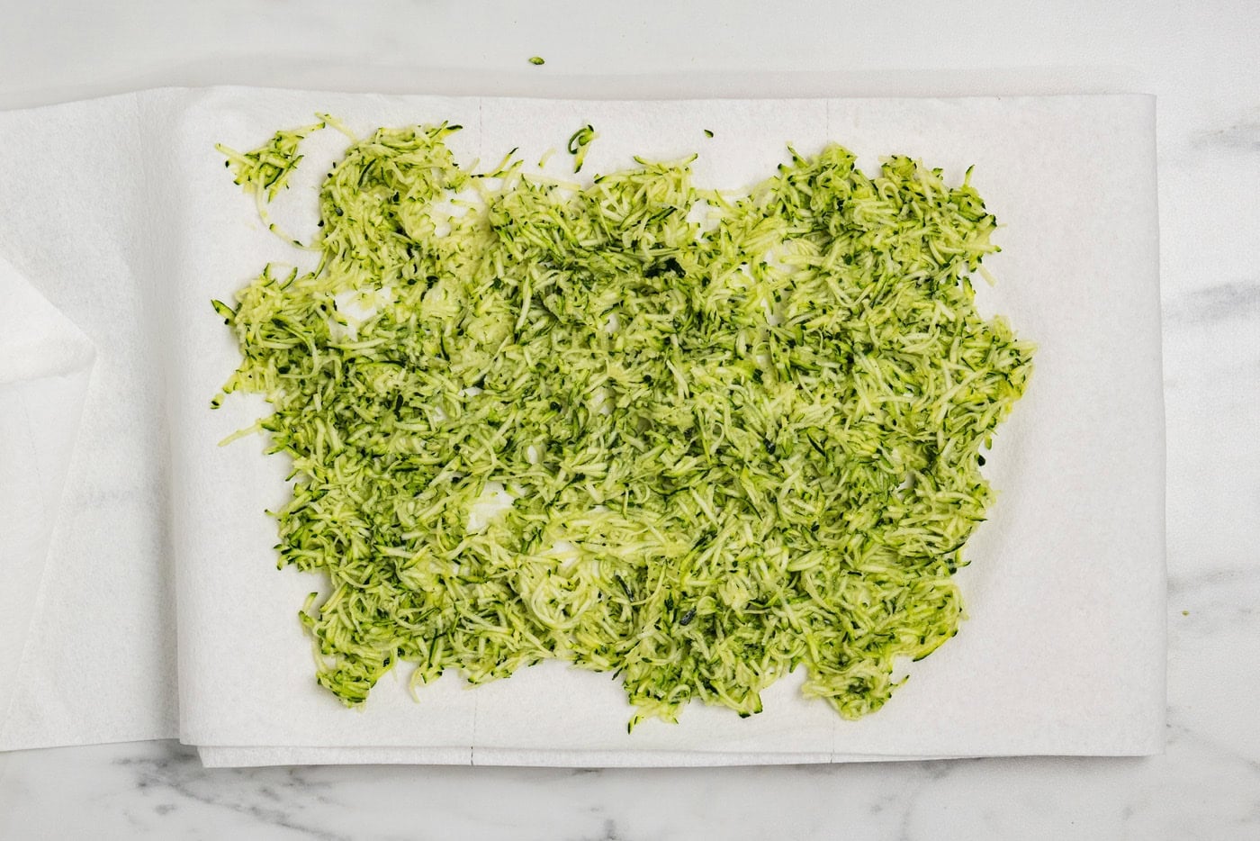 shredded zucchini on paper towels