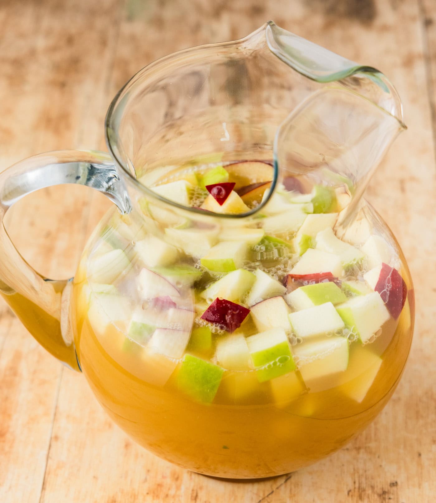 chopped applesm and dry white wine in a pitcher