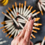 hand holding a Halloween Cigarette Pretzel