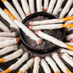 close up shot of Halloween Cigarette Pretzels in a dish that looks like an ashtray
