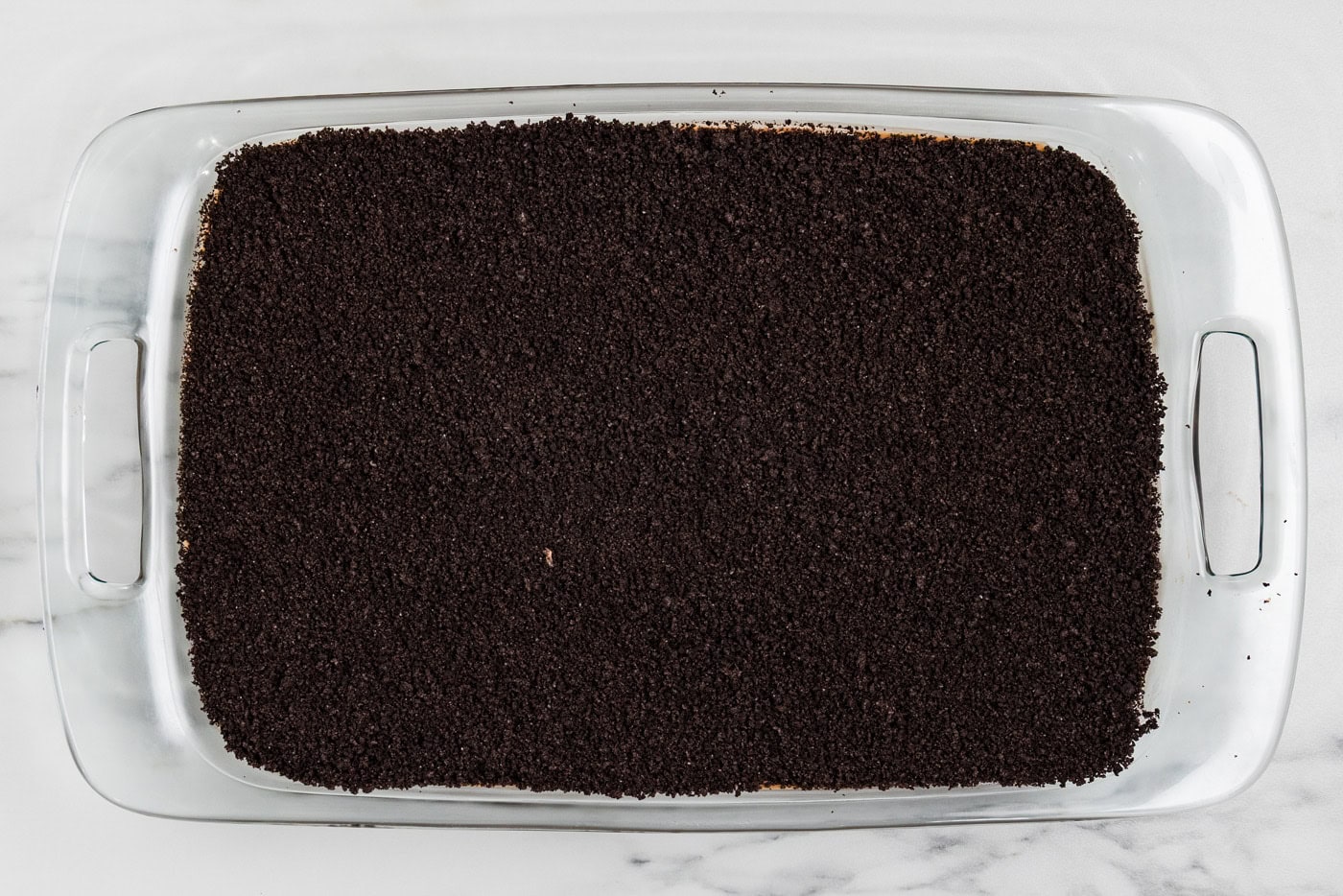 Reserved Oreo crumbs spread over the filling to look like a layer of dirt
