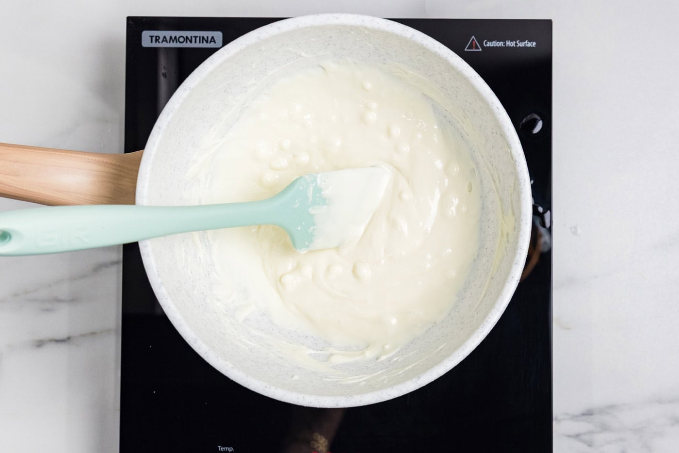 White chocolate melted smooth and stirred with a spatula over a double boiler