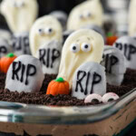 Halloween dirt cake graveyard seen at eye level in a glass baking dish