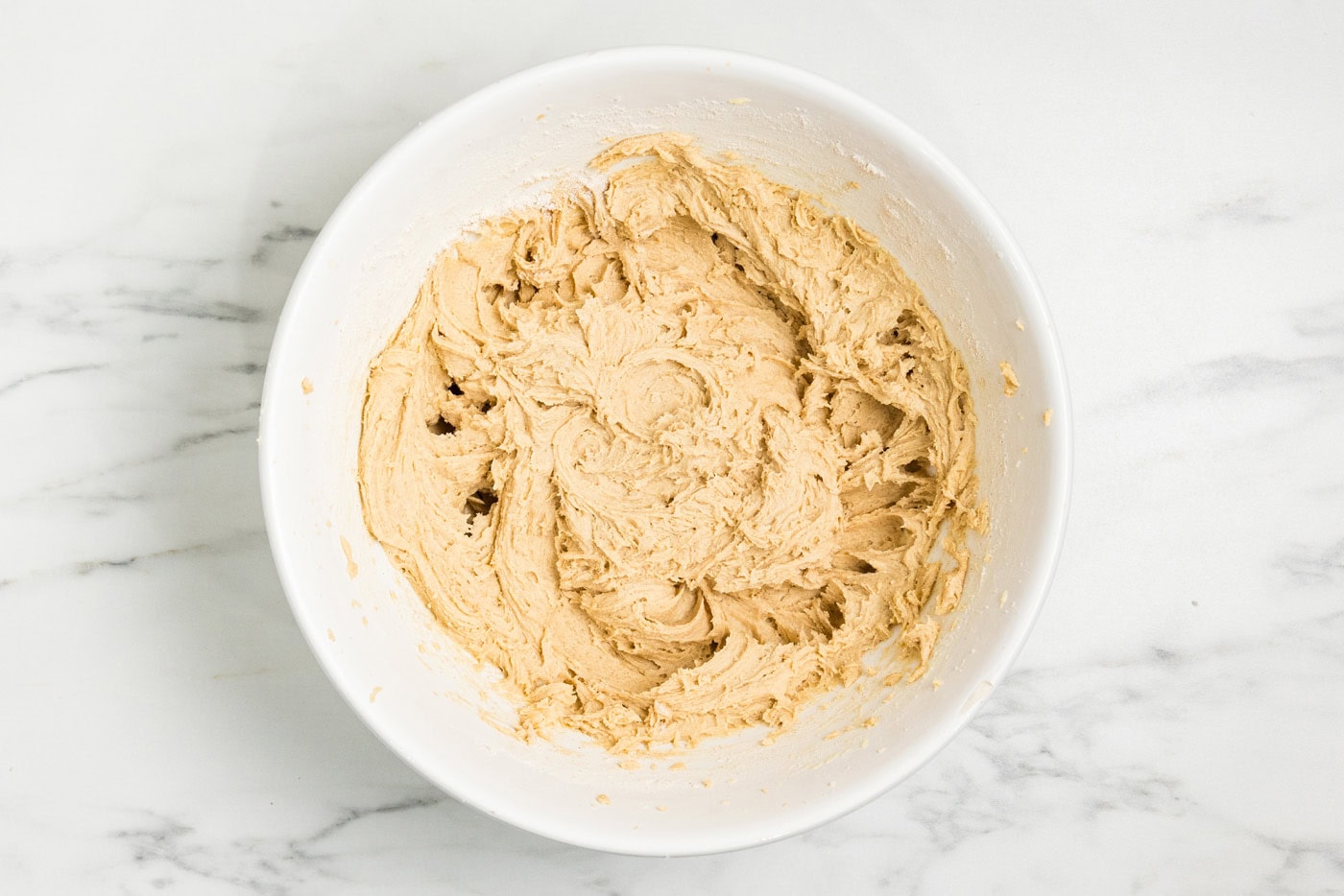 Finished cake batter in a white mixing bowl