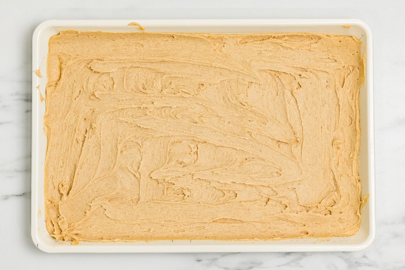 Half the cake batter spread into an ungreased jelly roll pan