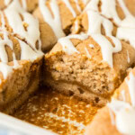 Close up of pumpkin pie squares in the pan with one square removed showing the pumpkin layer