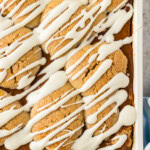 Overhead corner of a pan of pumpkin squares drizzled with cream cheese icing