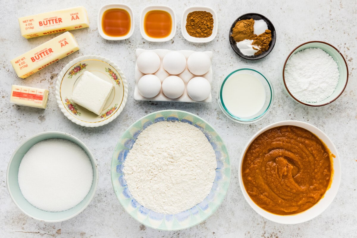Ingredients for pumpkin pie squares including canned pumpkin pie mix, butter, eggs, flour and cream cheese