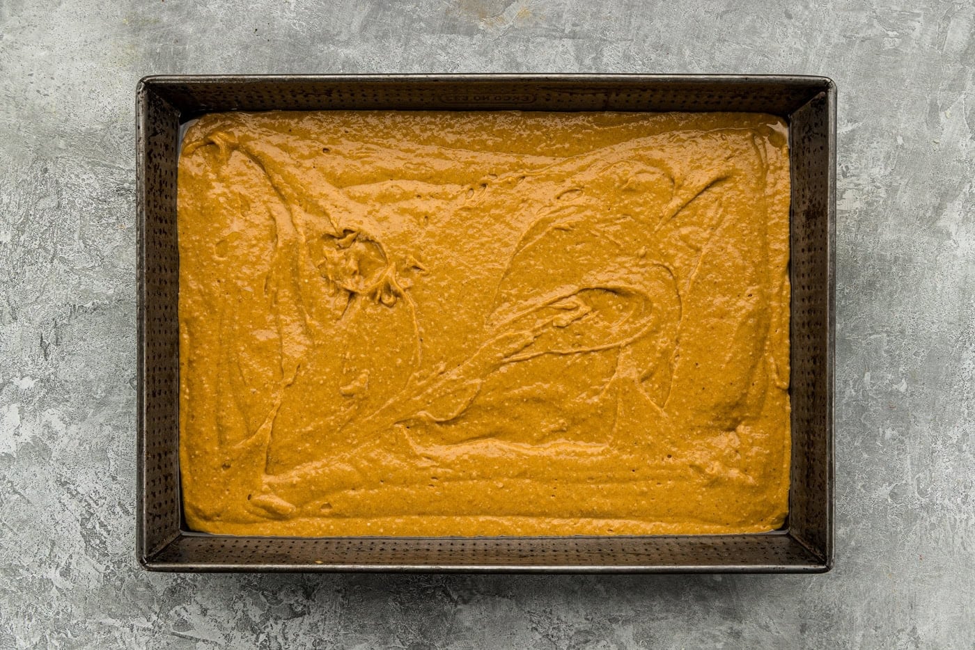 pumpkin cake batter in pan