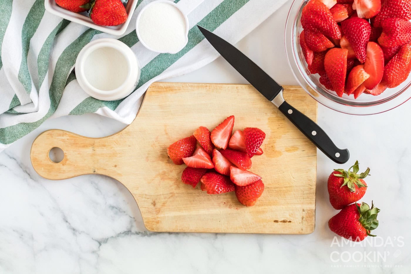 cut strawberries on a board