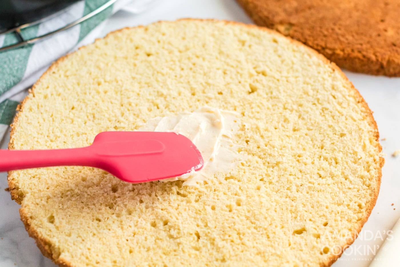spreading butter on cake layer