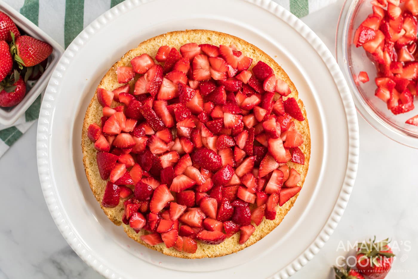 macerated strawberries on cake layer