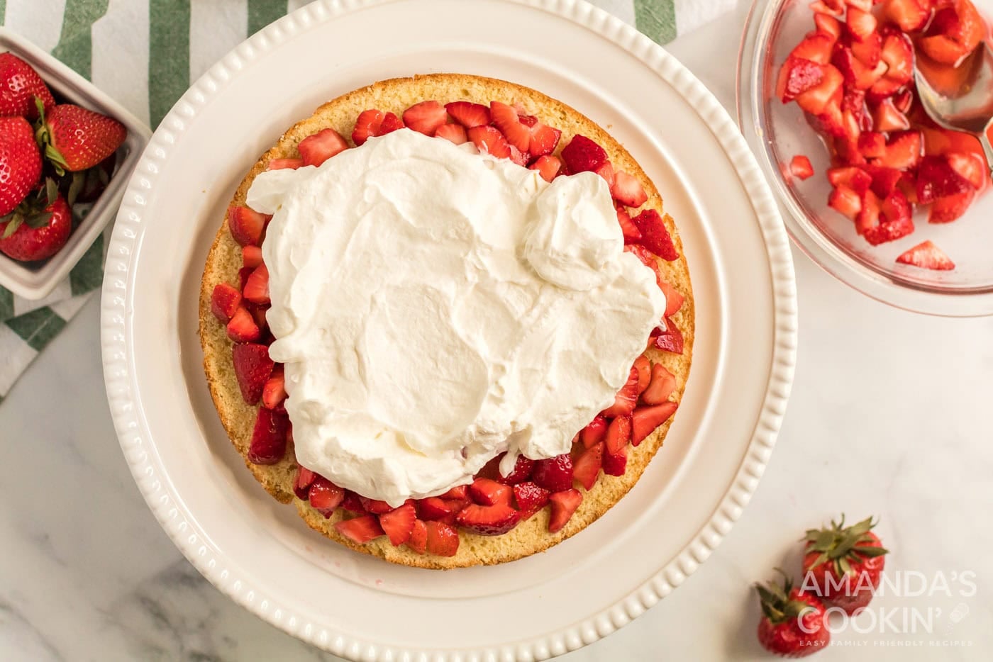 whipped cream spread over macerated strawberries