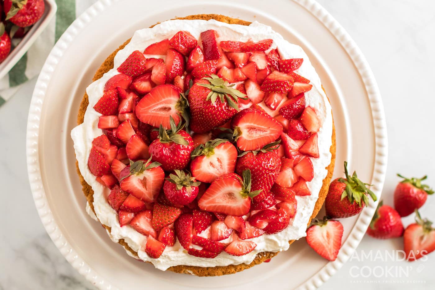 strawberries piled on top of cake