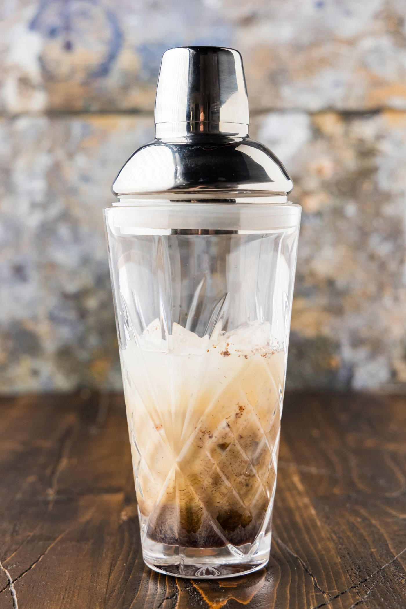 A capped cocktail shaker holding the mudslide ingredients before shaking