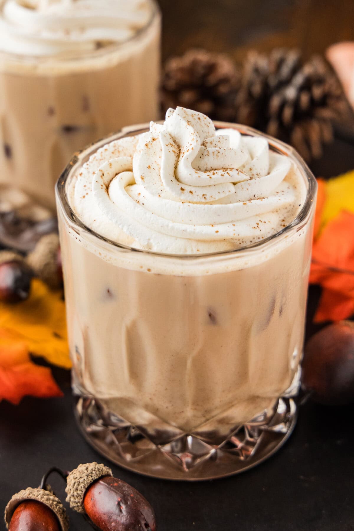 Close up of a creamy fall mudslide with a swirl of whipped cream dusted with pumpkin pie spice